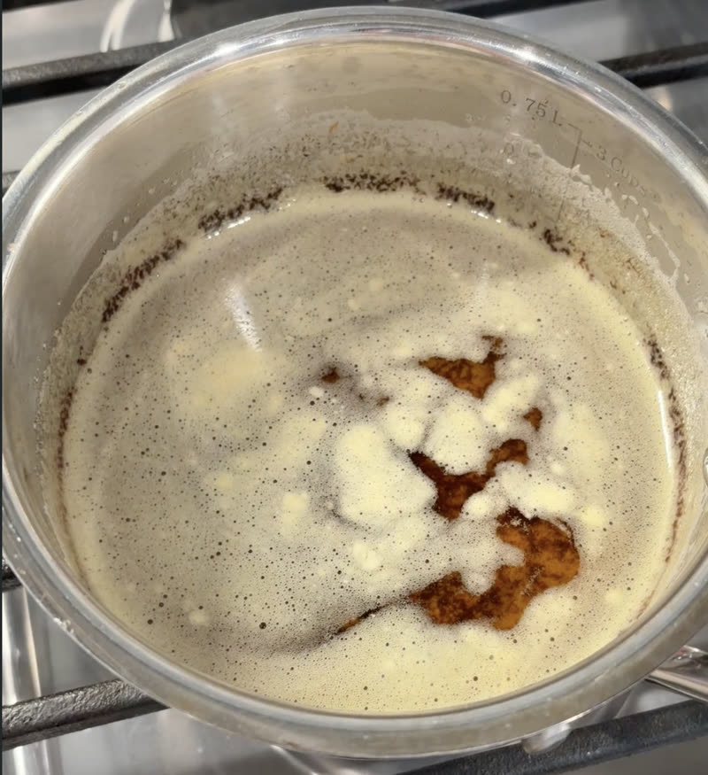 Finished ghee, clear golden with milk solids settled at the bottom